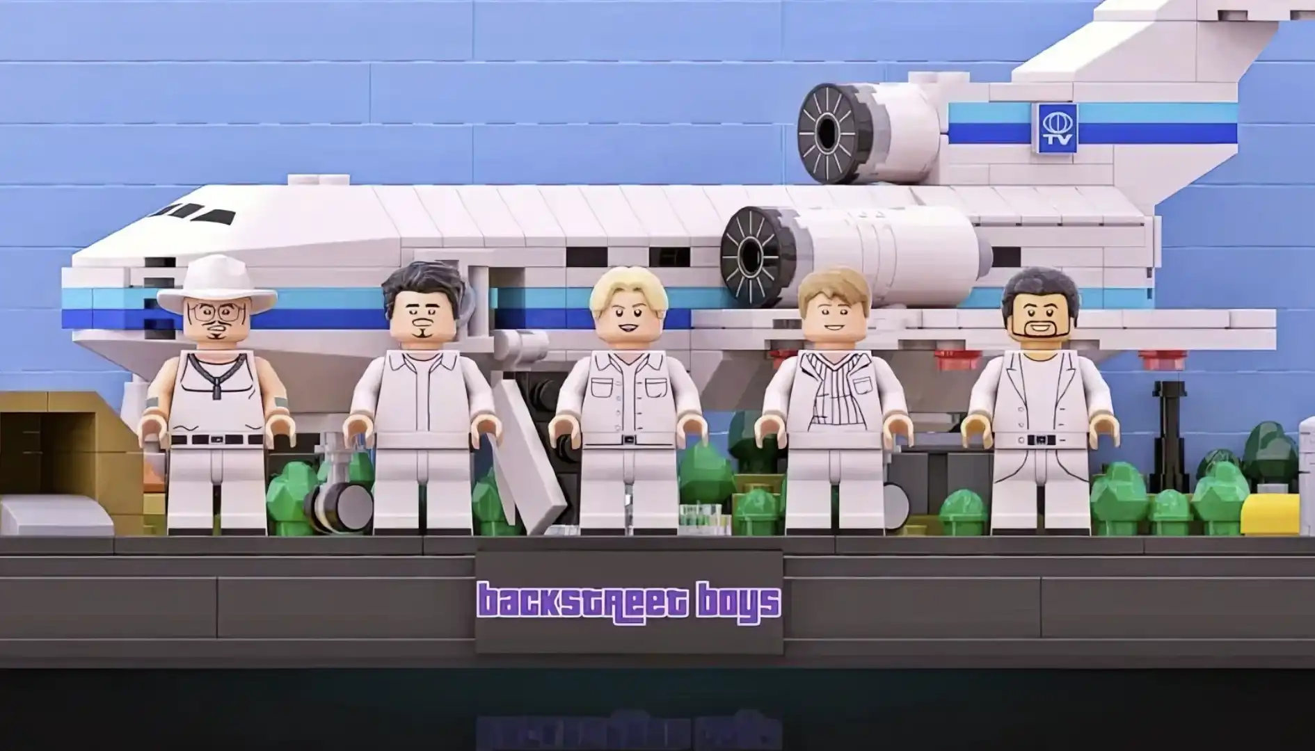 Uma foto frontal dos cinco membros da banda Backstreet Boys como minifigures LEGO, alinhados em primeiro plano.