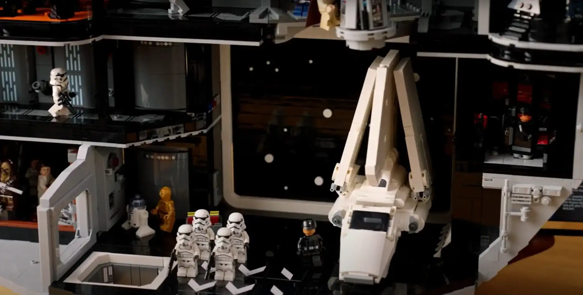 Detalhe de uma cena em LEGO dentro de uma réplica da Estrela da Morte. A cena mostra a nave T-4a Imperial Shuttle, stormtroopers e outras minifiguras em uma área de hangar.